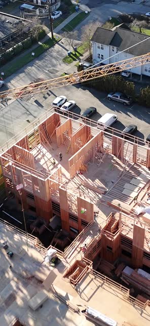 Corner view of wood framing with crane boom