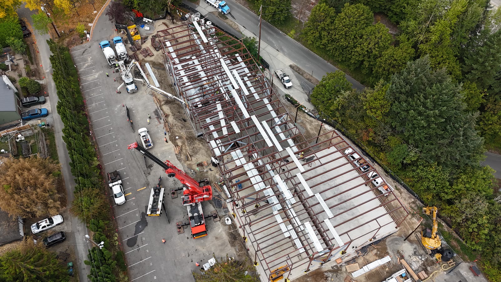 Overhead view of the deck pour with the boom pump and concrete trucks on site