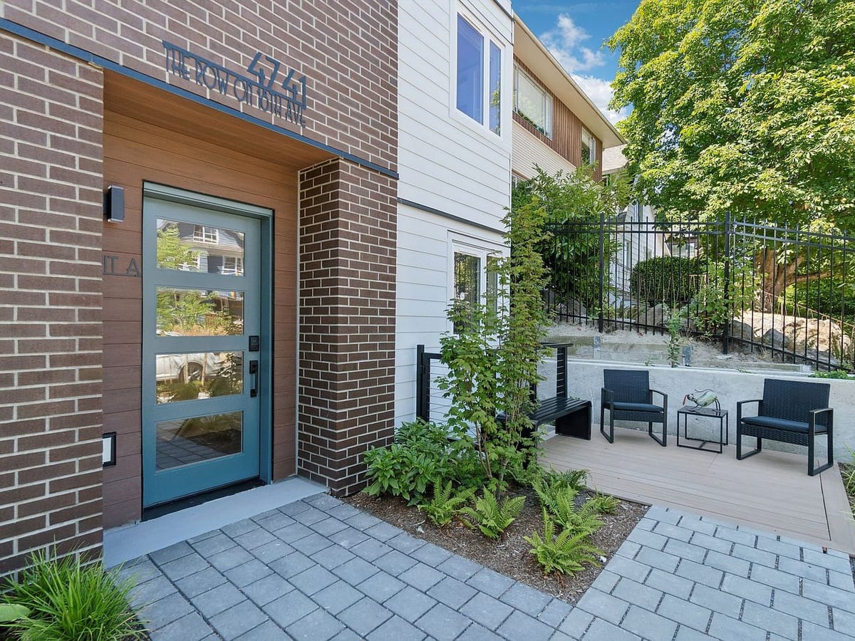Brick and lap-siding entry with patio seating